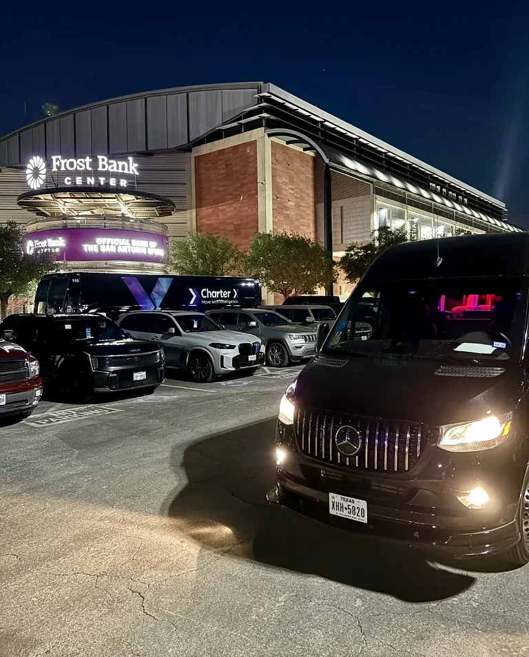 ETI-supplied nighttime photograph of ground transportation and a CharterX coach outside a venue